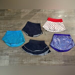 Skating/dance skirt lot.  Skirts range from denim to flashy sequins.